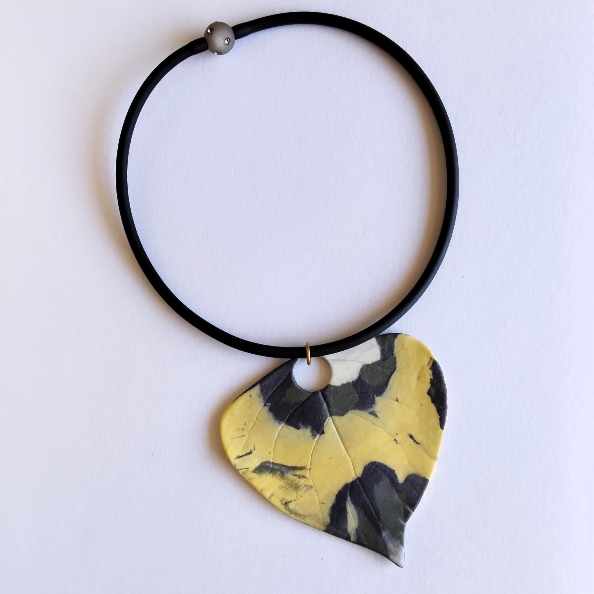 Collana Pendente Foglia Porcellana Nerikomi posa dall'alto su cartoncino bianco – colori della terra – Maviart